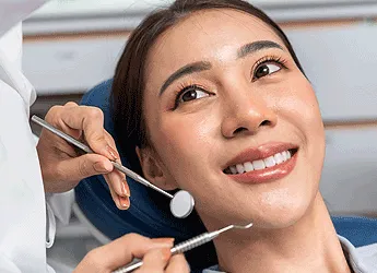 A smiling woman receiving a dental checkup
