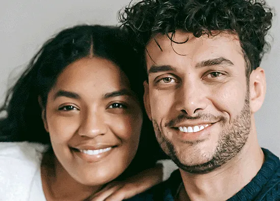 Close-up portrait of a smiling mixed-race couple